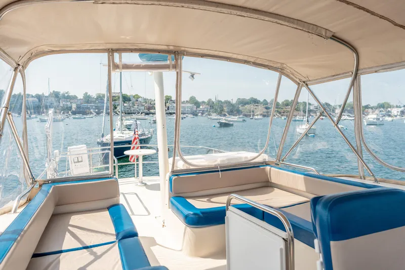  Yacht Photos Pics 2005 Mainship 400 Trawler interior with blue seating, overlooking a scenic harbor view.