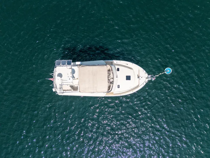  Yacht Photos Pics Aerial view of 2005 Mainship 400 Trawler on calm water.