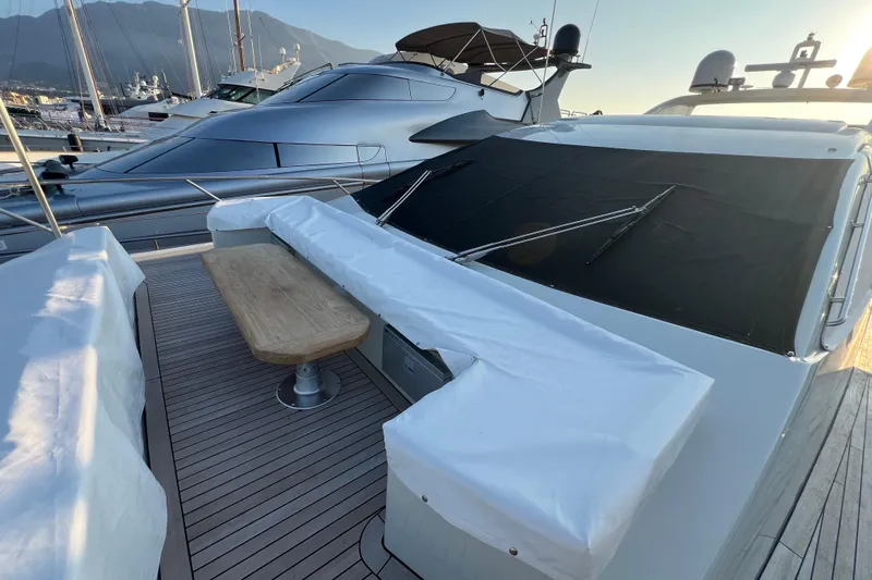 Rus&egrave; Yacht Photos Pics 2006 Azimut 86 Sport yacht deck with covered seating and table, docked at marina.