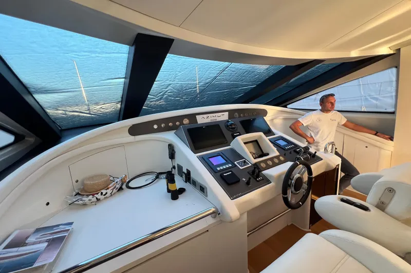 Rus&egrave; Yacht Photos Pics Cockpit of 2006 Azimut 86 Sport yacht with modern controls and seating.