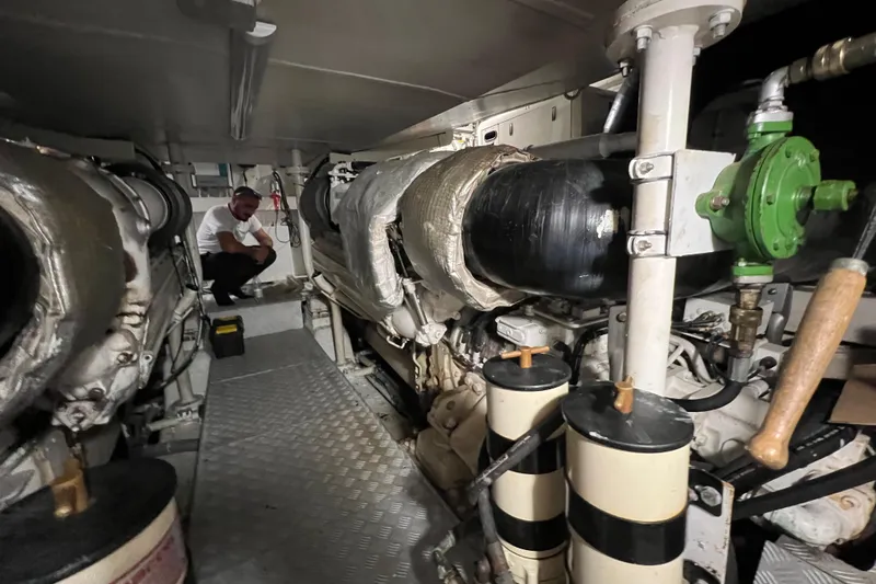 Rus&egrave; Yacht Photos Pics Engine room of a 2006 Azimut 86 Sport yacht with visible machinery and a person inspecting.