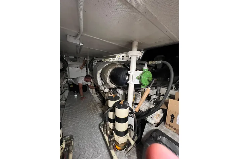 Rus&egrave; Yacht Photos Pics Engine room of 2006 Azimut 86 Sport yacht with visible machinery and maintenance activity.