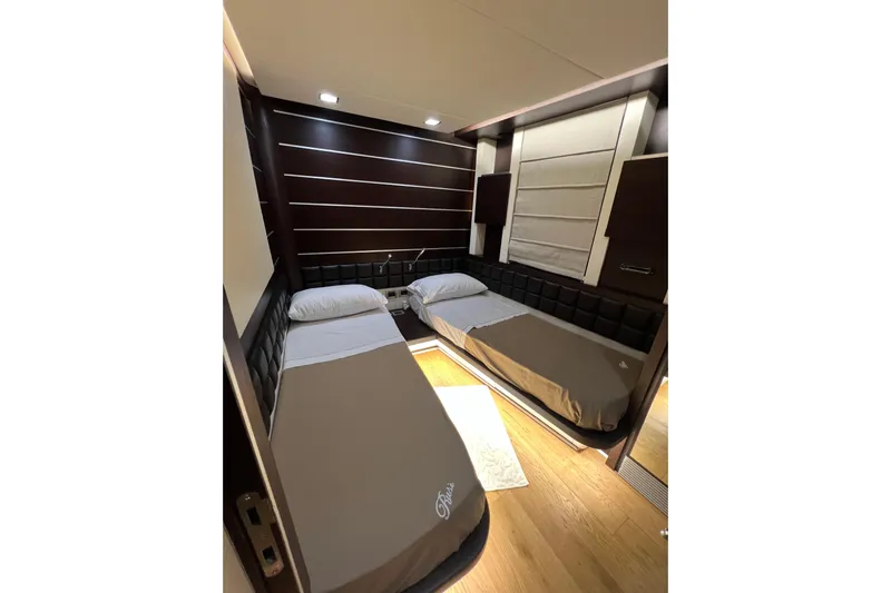Rus&egrave; Yacht Photos Pics Luxurious twin bedroom in 2006 Azimut 86 Sport yacht, featuring modern design and ambient lighting.
