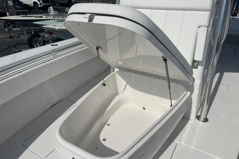  Yacht Photos Pics Open storage compartment on 2026 Contender 32 ST boat, showcasing spacious interior design.