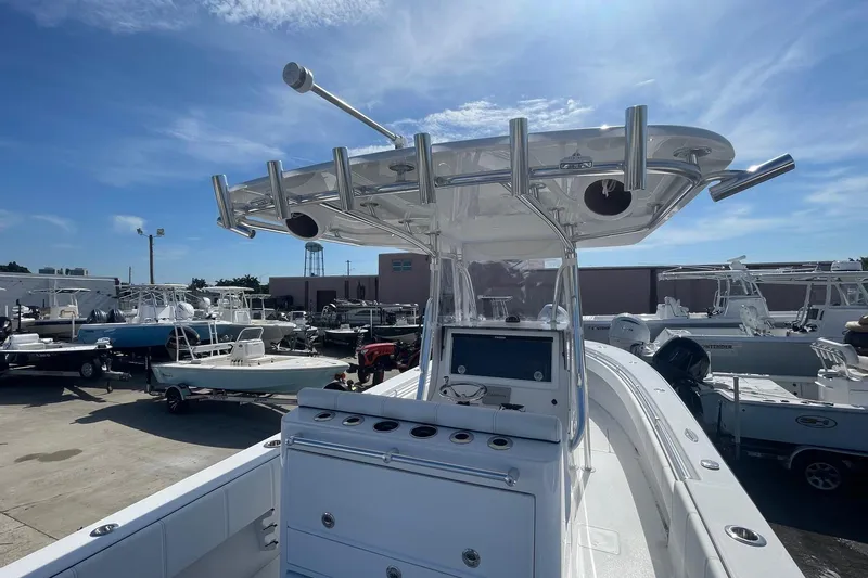 Yacht Photos Pics 2026 Contender 32 ST boat with T-top and rod holders in a marina setting.
