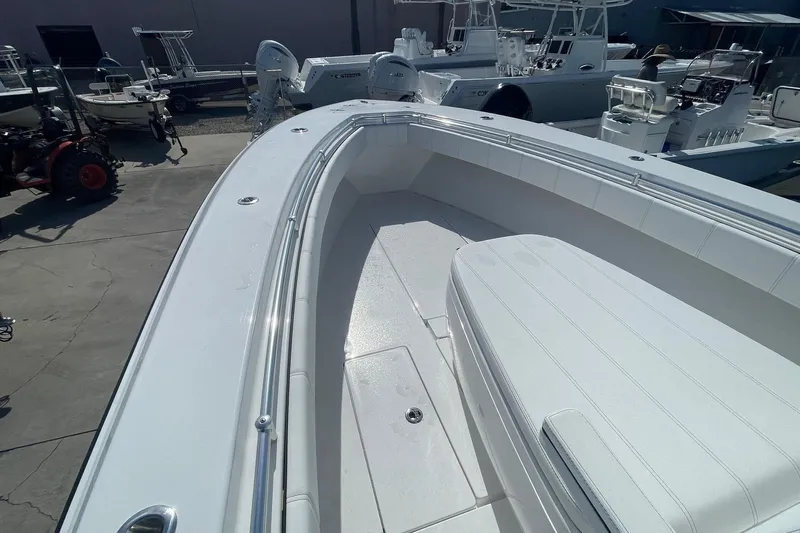  Yacht Photos Pics 2026 Contender 32 ST boat, sleek white deck, spacious seating, outdoor display.