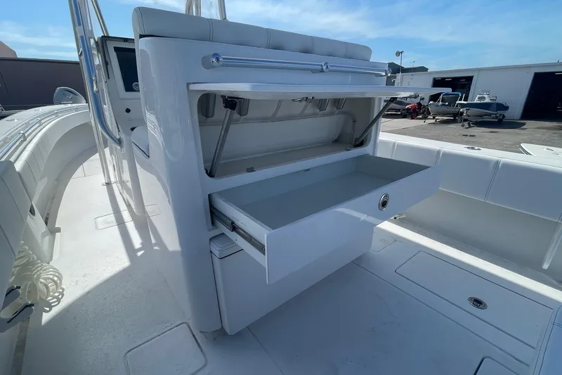  Yacht Photos Pics 2026 Contender 32 ST boat with open storage compartments on deck.