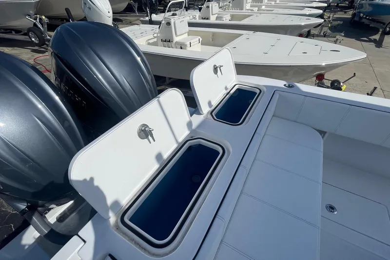  Yacht Photos Pics 2026 Contender 32 ST boat with open storage compartments and dual outboard engines.