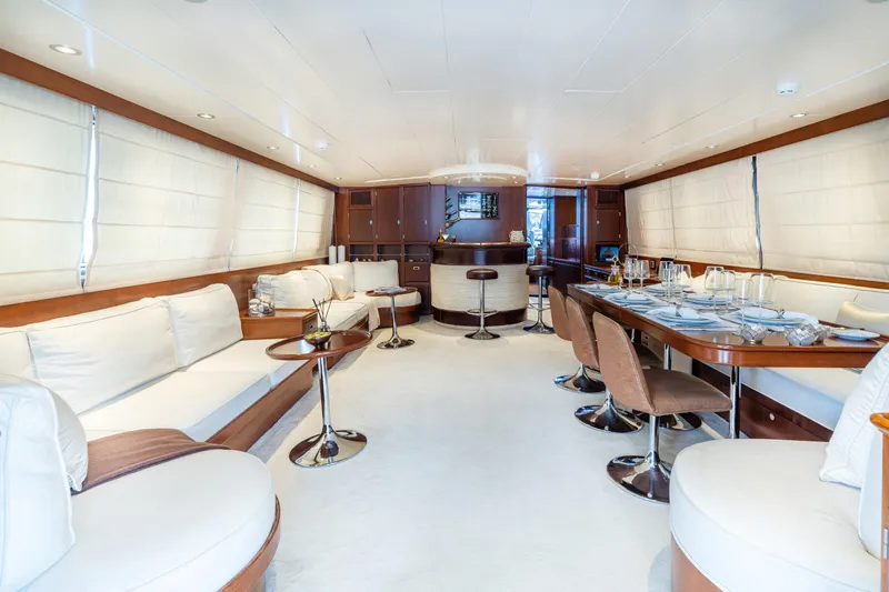 Anonymous Yacht Photos Pics Luxurious yacht interior with elegant dining area, plush seating, and modern decor, Hellenic Shipyards 1981.