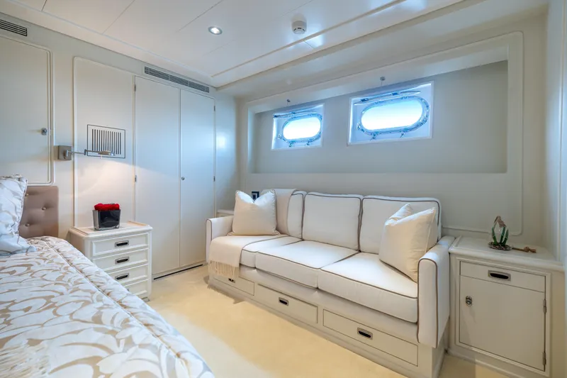 Anonymous Yacht Photos Pics Luxurious yacht cabin interior with white sofa, elegant decor, and porthole windows, Hellenic Shipyards 1981.