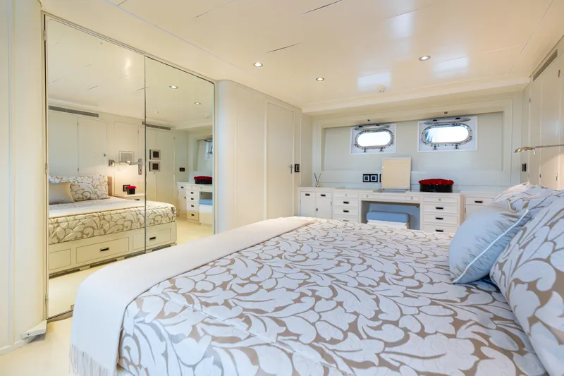 Anonymous Yacht Photos Pics Luxurious yacht bedroom with elegant decor, mirrored closet, and porthole windows, Hellenic Shipyards Custom 1981.