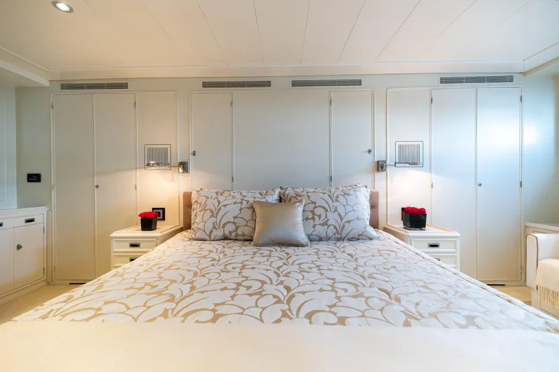 Anonymous Yacht Photos Pics Luxurious yacht bedroom with elegant decor, featuring floral bedding and ambient lighting, Hellenic Shipyards 1981.