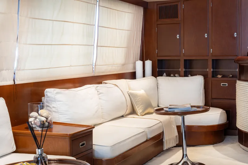 Anonymous Yacht Photos Pics Luxurious yacht interior with white cushions, wooden cabinets, and elegant decor, Hellenic Shipyards 1981.