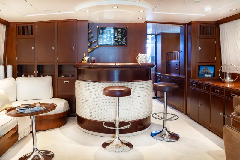 Anonymous Yacht Photos Pics Luxurious yacht interior with elegant bar, stools, and plush seating, Hellenic Shipyards Custom 1981.