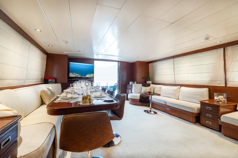 Anonymous Yacht Photos Pics Luxurious yacht interior with elegant dining area, plush seating, and modern decor, Hellenic Shipyards 1981.