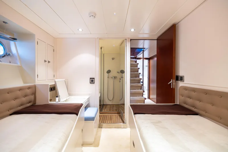 Anonymous Yacht Photos Pics Luxurious yacht cabin with twin beds, ensuite shower, and modern decor, Hellenic Shipyards 1981.