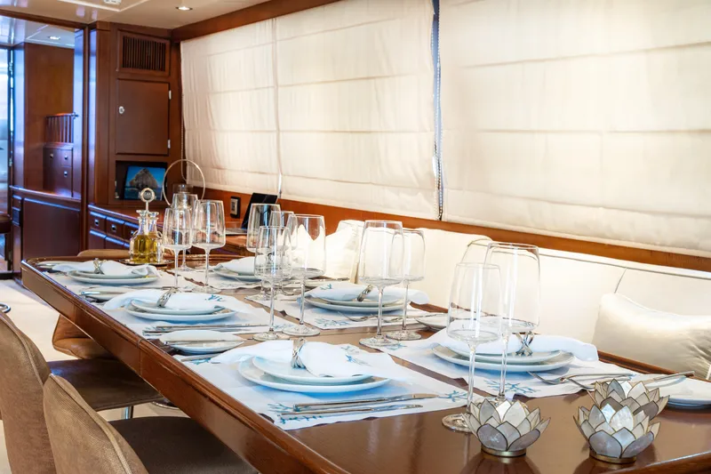 Anonymous Yacht Photos Pics Luxurious dining area on a 1981 Hellenic Shipyards custom yacht, elegantly set table.