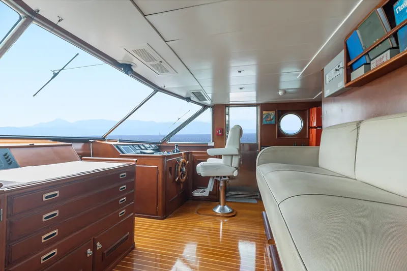 Anonymous Yacht Photos Pics Luxurious 1981 Hellenic Shipyards custom yacht interior with wooden finishes and panoramic sea view.