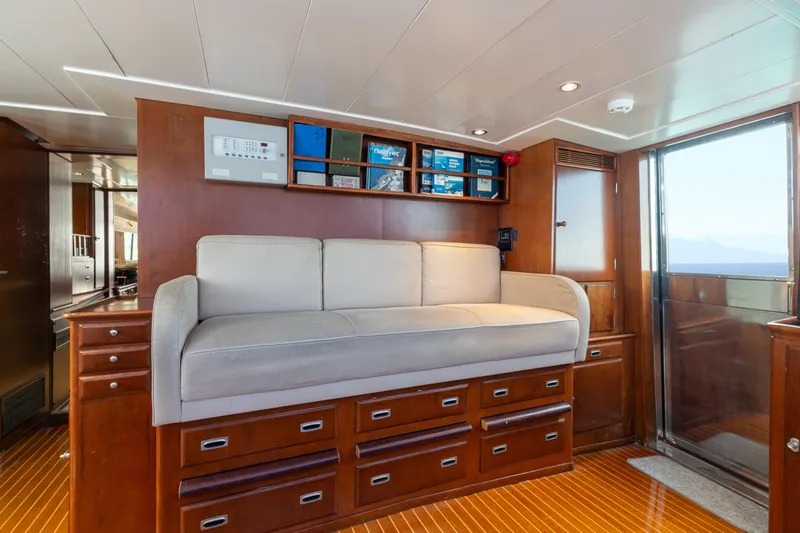 Anonymous Yacht Photos Pics Luxurious yacht interior with wooden cabinetry, cushioned seating, and ample storage, Hellenic Shipyards 1981.