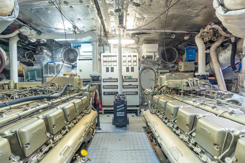 Anonymous Yacht Photos Pics Engine room of 1981 Hellenic Shipyards custom vessel, featuring dual engines and control panels.