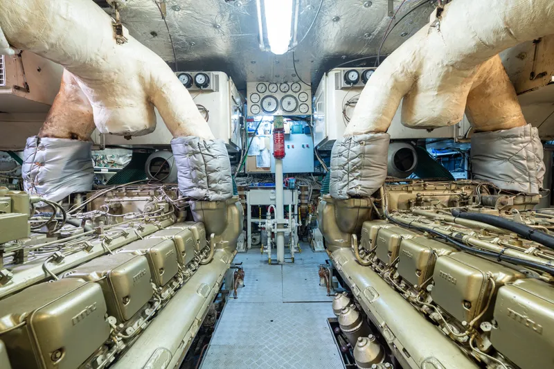 Anonymous Yacht Photos Pics Engine room of 1981 Hellenic Shipyards custom vessel, featuring complex machinery and control panels.