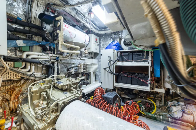 Anonymous Yacht Photos Pics Engine room of 1981 Hellenic Shipyards custom model, featuring complex machinery and wiring.