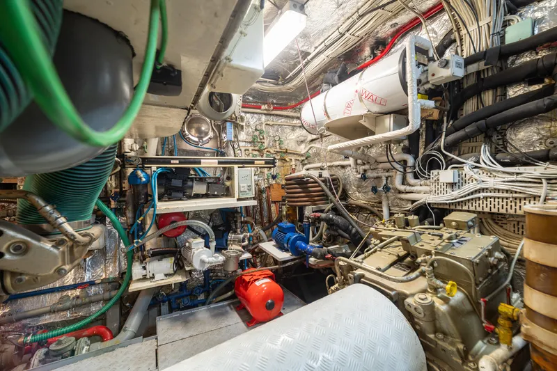 Anonymous Yacht Photos Pics Engine room of 1981 Hellenic Shipyards custom vessel, showcasing complex machinery and wiring.
