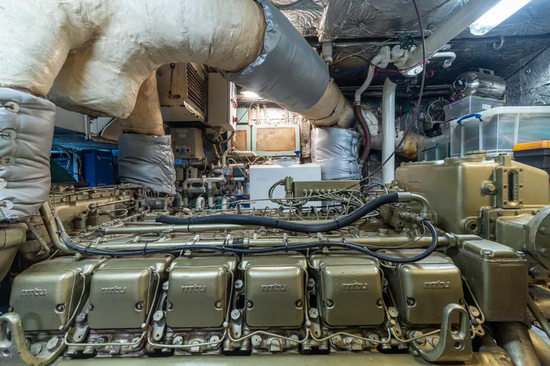 Anonymous Yacht Photos Pics Engine room of 1981 Hellenic Shipyards custom vessel, showcasing complex machinery and piping.
