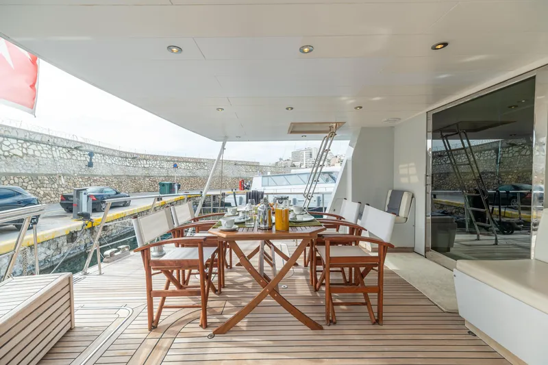Anonymous Yacht Photos Pics Luxury yacht deck with dining setup, Hellenic Shipyards Custom, 1981 model.