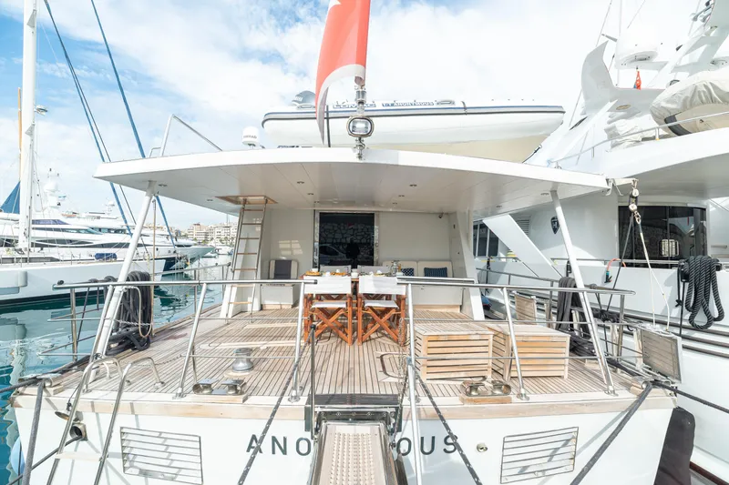 Anonymous Yacht Photos Pics Luxury yacht deck with dining area, Hellenic Shipyards Custom, 1981 model, docked at marina.