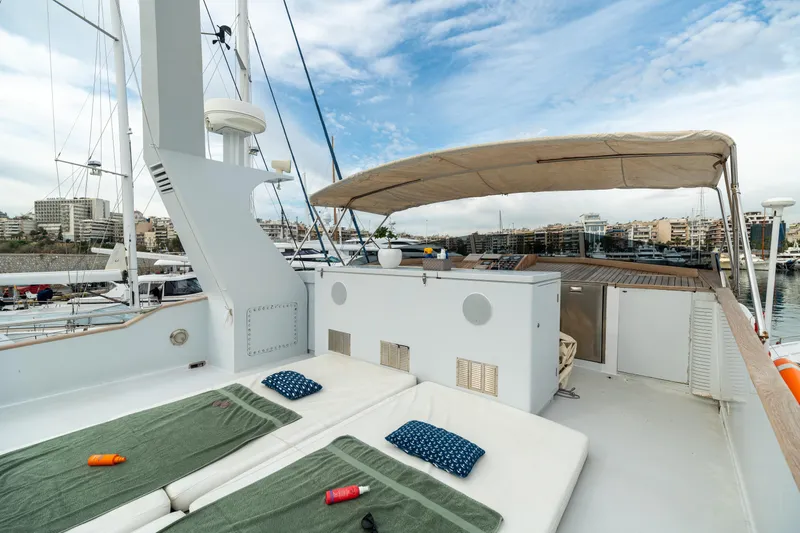Anonymous Yacht Photos Pics Luxury yacht deck with sunbeds, canopy, and cityscape view; Hellenic Shipyards Custom, 1981.