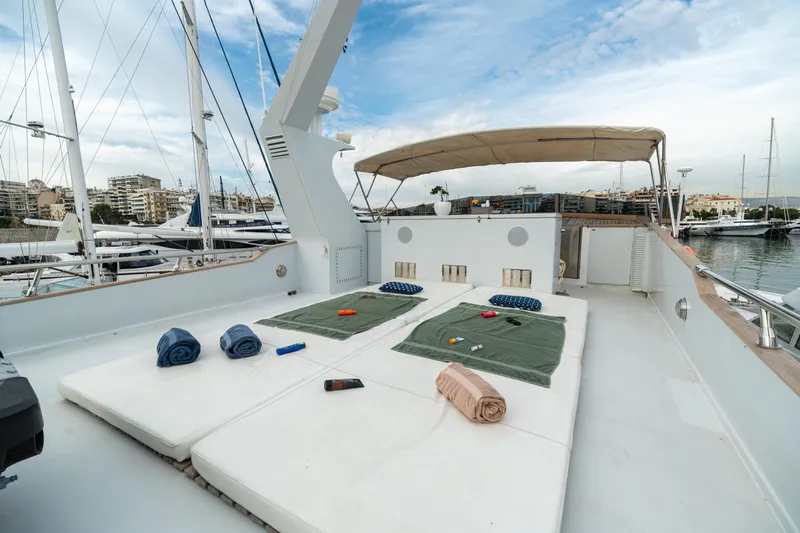 Anonymous Yacht Photos Pics Luxurious 1981 Hellenic Shipyards custom yacht deck with sunbeds and marina view.