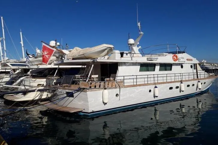 Anonymous Yacht Photos Pics Luxury yacht docked at marina, Hellenic Shipyards Custom model, 1981, under clear blue sky.