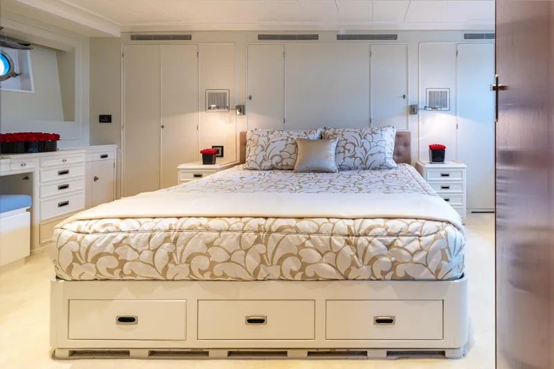 Anonymous Yacht Photos Pics Luxurious yacht bedroom with elegant bedding, built-in storage, and soft lighting, Hellenic Shipyards 1981.