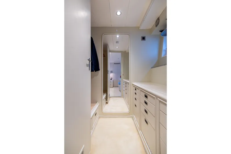 Anonymous Yacht Photos Pics Narrow hallway with mirror and cabinets on a 1981 Hellenic Shipyards custom vessel.