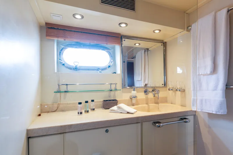Anonymous Yacht Photos Pics Luxurious yacht bathroom with porthole, mirror, and elegant fixtures, Hellenic Shipyards Custom 1981.