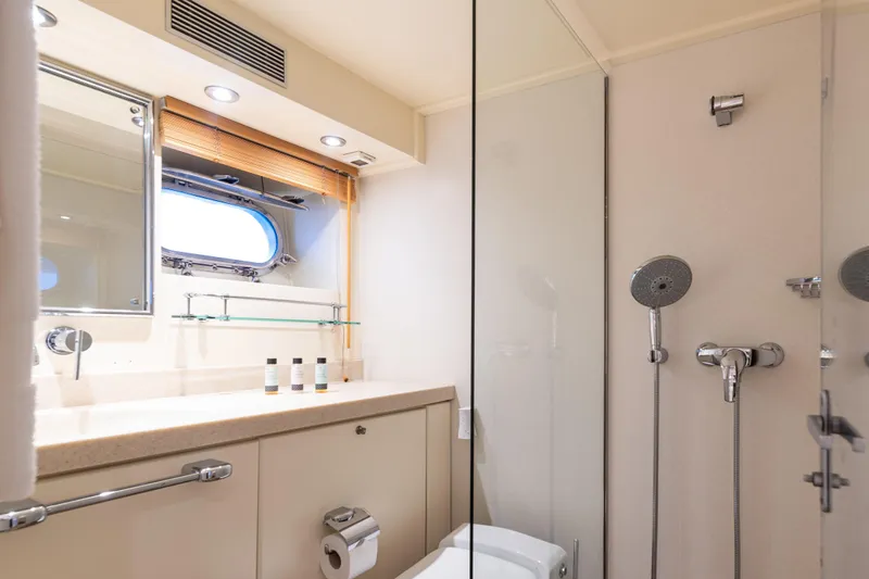 Anonymous Yacht Photos Pics Luxurious yacht bathroom with modern fixtures, glass shower, and porthole window, Hellenic Shipyards 1981.