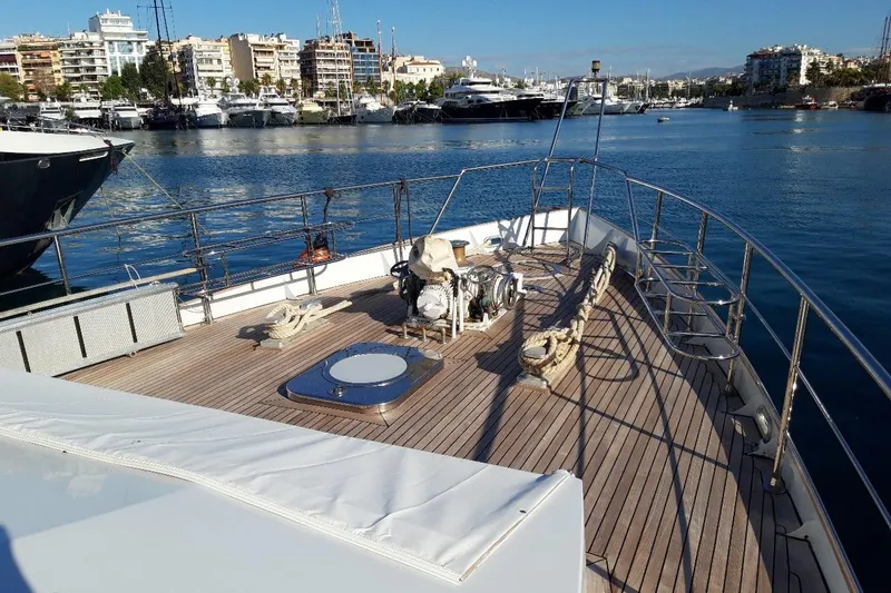 Anonymous Yacht Photos Pics Deck of 1981 Hellenic Shipyards Custom yacht in marina, with cityscape background.