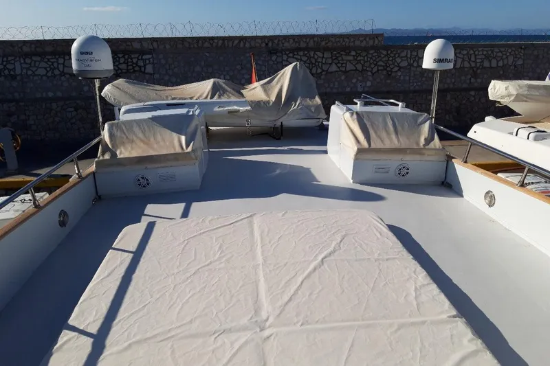 Anonymous Yacht Photos Pics Deck of 1981 Hellenic Shipyards Custom yacht with covered equipment and clear sky.