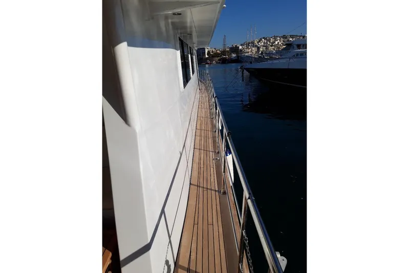 Anonymous Yacht Photos Pics Side deck view of 1981 Hellenic Shipyards custom yacht, docked in a marina.
