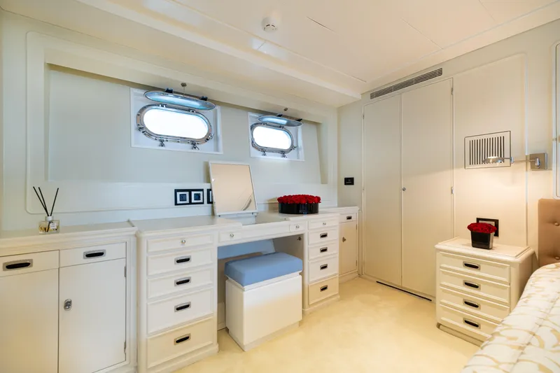 Anonymous Yacht Photos Pics Luxurious yacht cabin interior with elegant white furnishings, vanity, and porthole windows, Hellenic Shipyards 1981.