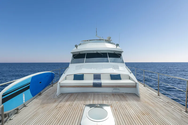 Anonymous Yacht Photos Pics Luxury yacht deck with seating, paddleboard, and ocean view; Hellenic Shipyards Custom, 1981.