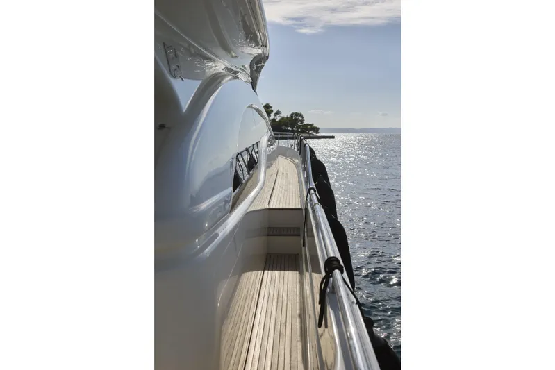  Yacht Photos Pics Side view of 2004 Ferretti Yachts 680 on calm sea, sunny day.