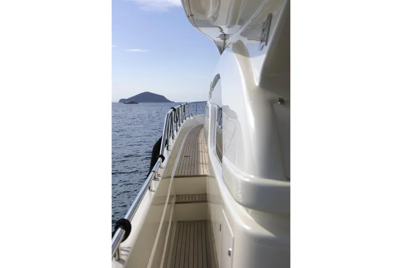  Yacht Photos Pics 2004 Ferretti Yachts 680 side deck view with ocean and island backdrop.