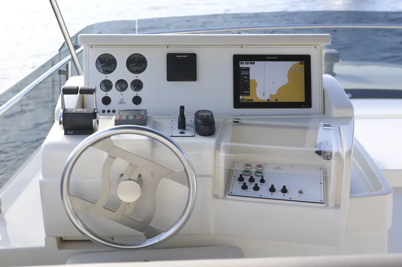  Yacht Photos Pics Helm of 2004 Ferretti Yachts 680 with navigation controls and steering wheel.