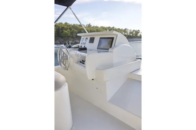  Yacht Photos Pics Helm of 2004 Ferretti Yachts 680 with navigation equipment and steering wheel.
