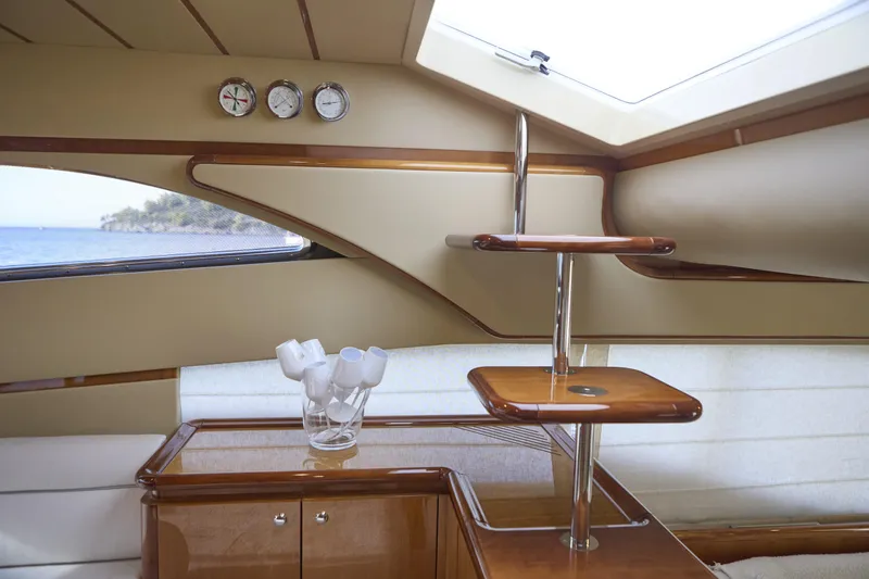  Yacht Photos Pics Luxurious interior of 2004 Ferretti Yachts 680 with elegant wood finishes and nautical instruments.