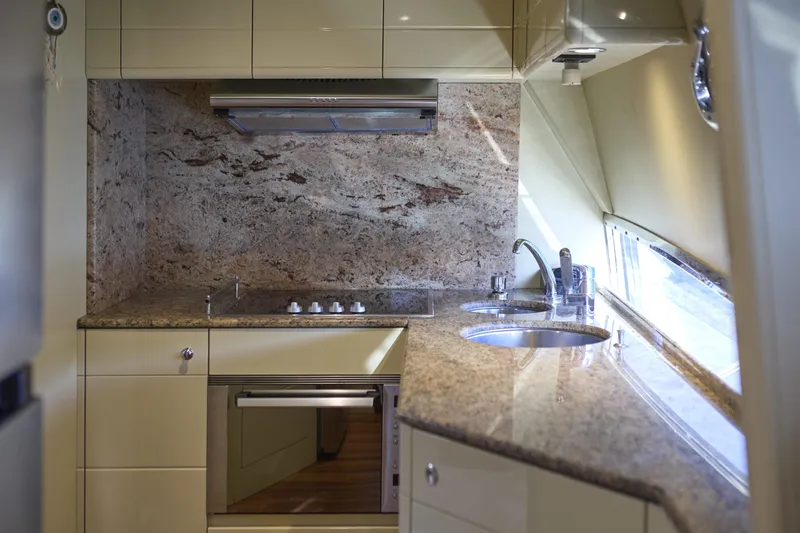  Yacht Photos Pics Luxurious kitchen interior of 2004 Ferretti Yachts 680 with granite countertops and modern appliances.