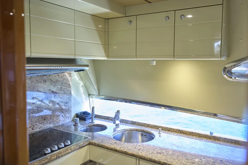  Yacht Photos Pics Luxurious kitchen interior of 2004 Ferretti Yachts 680 with granite countertops and modern appliances.