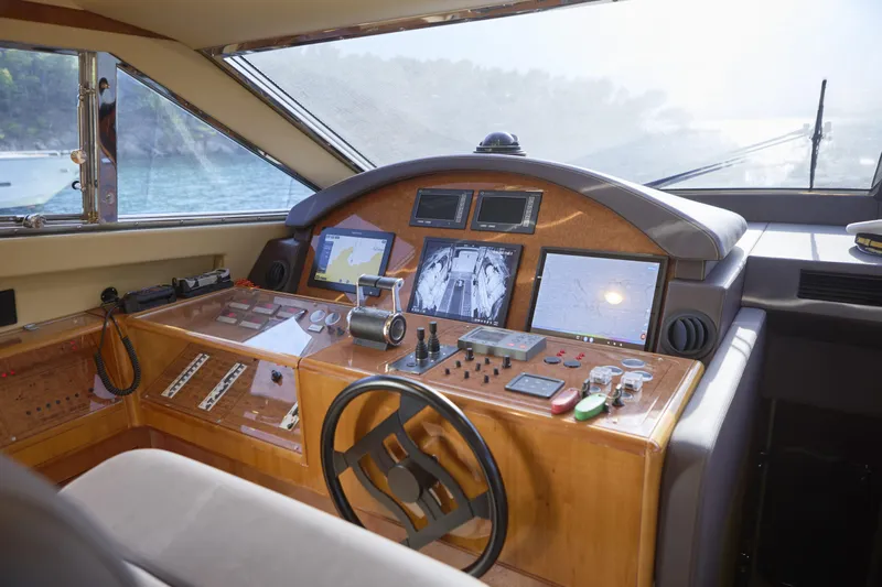  Yacht Photos Pics Cockpit of 2004 Ferretti Yachts 680 with navigation screens and controls.